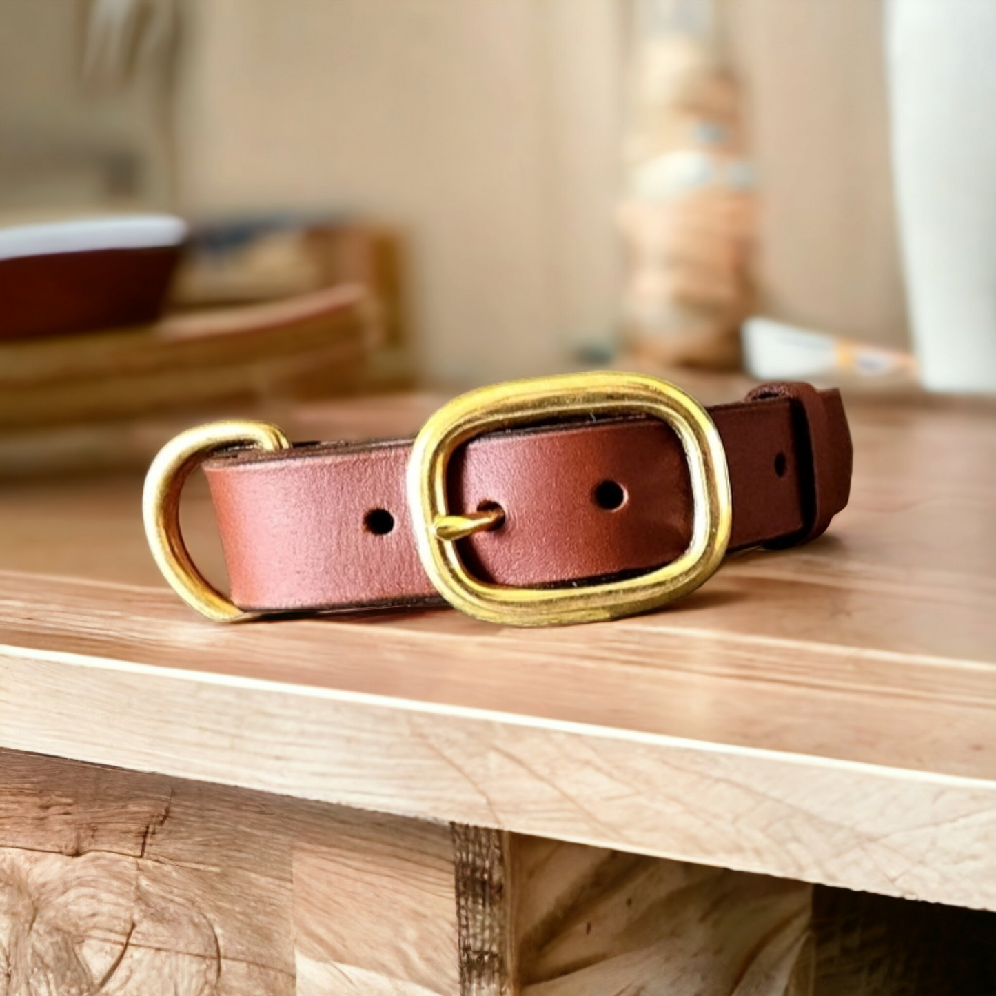 The working or larger, leather dog collar in brass swage buckles