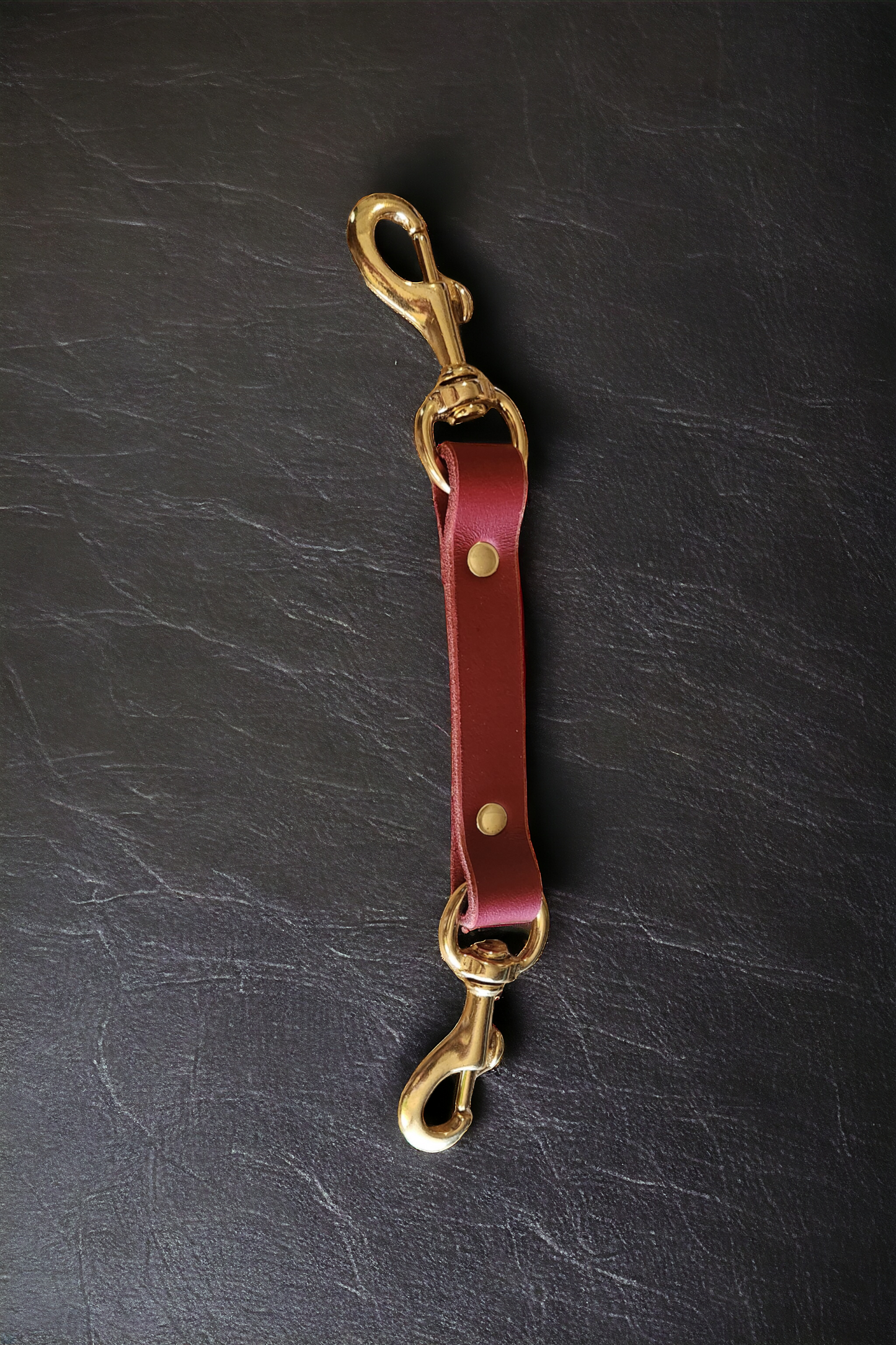 Bondage Double ended clip and leather with snaps.